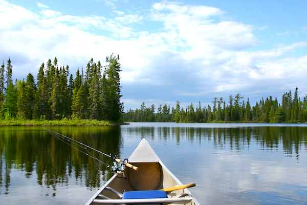 Aluminum canoe with fishing gear heading out on a northern Minnesota lake